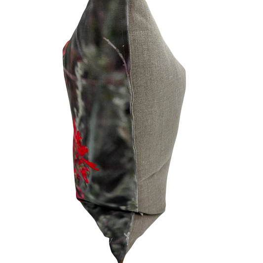 Side view — Indian Paintbrush pillow showing the printed floral front and natural linen back