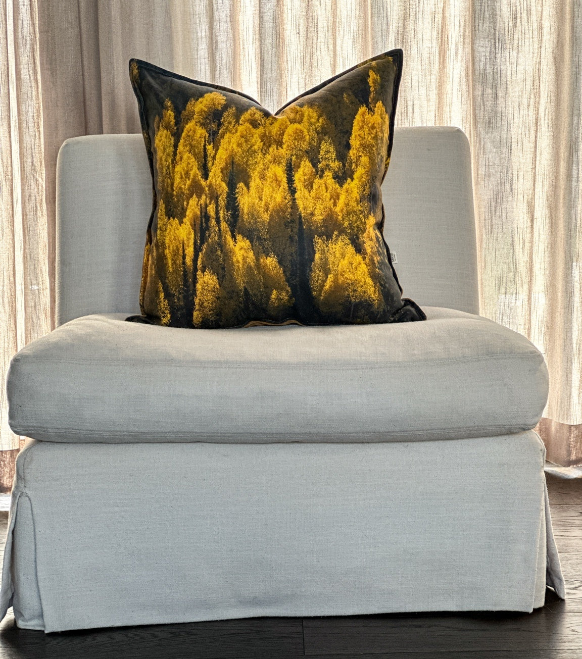 Aspen Gold pillow styled on a chair — golden Utah aspens on natural linen.