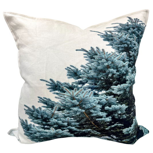 Blue Spruce pillow on natural linen fabric featuring detailed Utah evergreen branches.