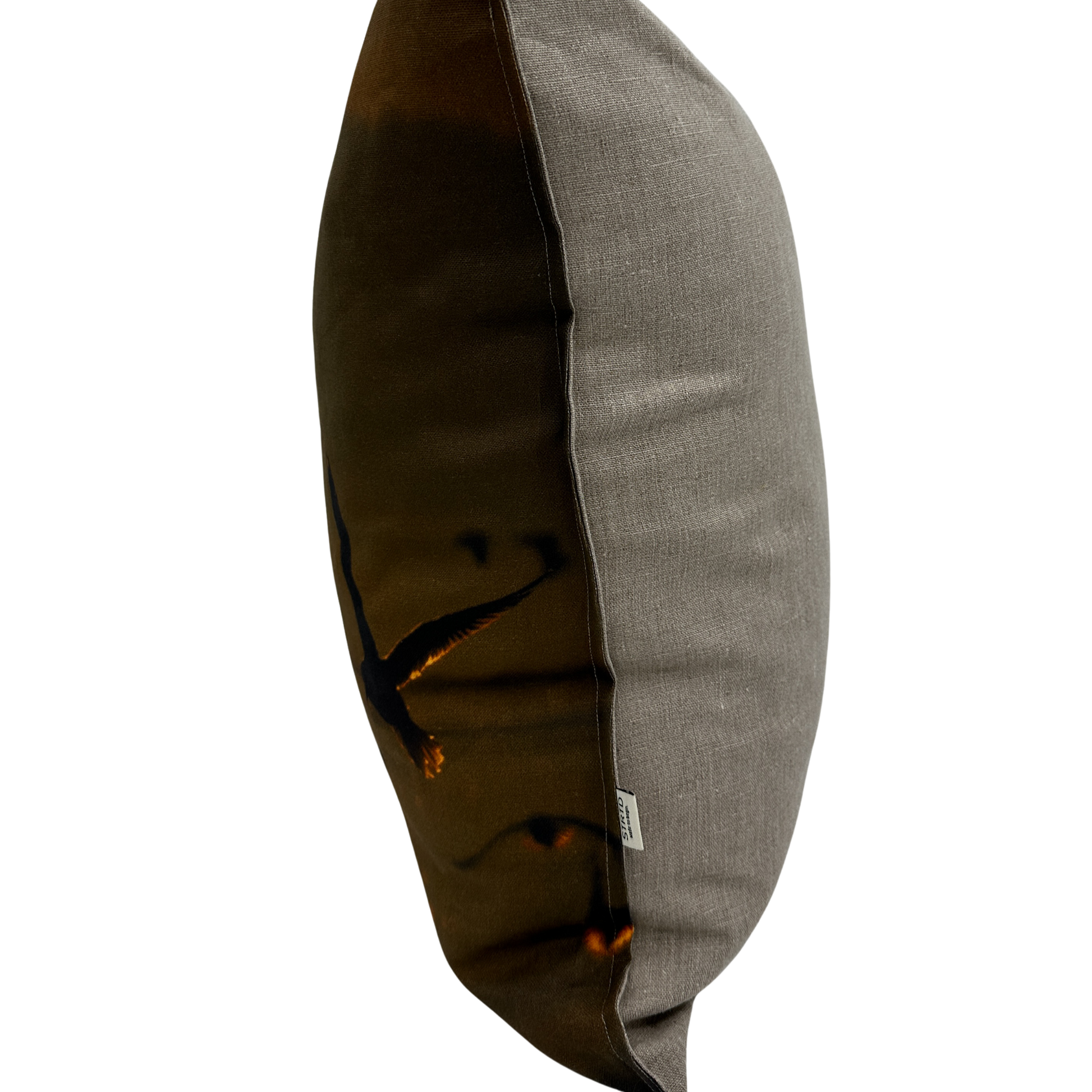 Side view of Gull Flight pillow showing the natural linen texture and sunset bird print.