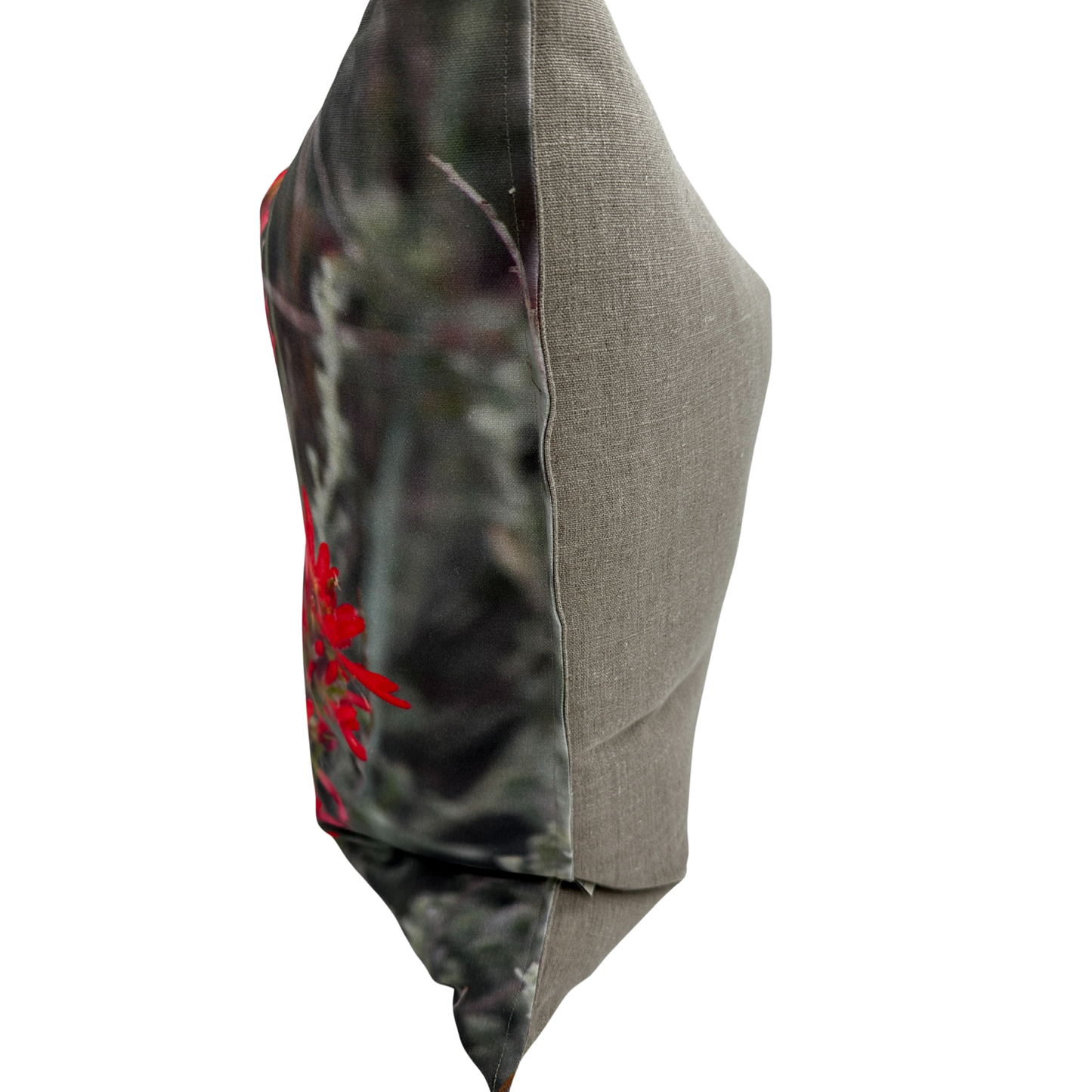 Side view — Indian Paintbrush pillow showing the printed floral front and natural linen back