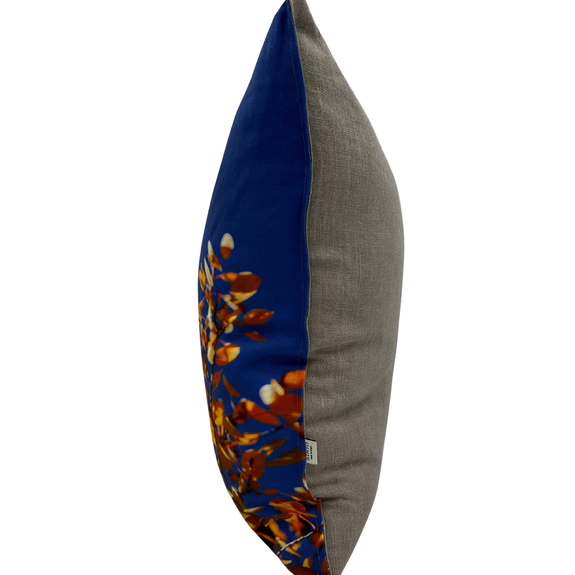 Side view of Aspen Sky pillow showing the natural linen texture and bold blue-and-gold print