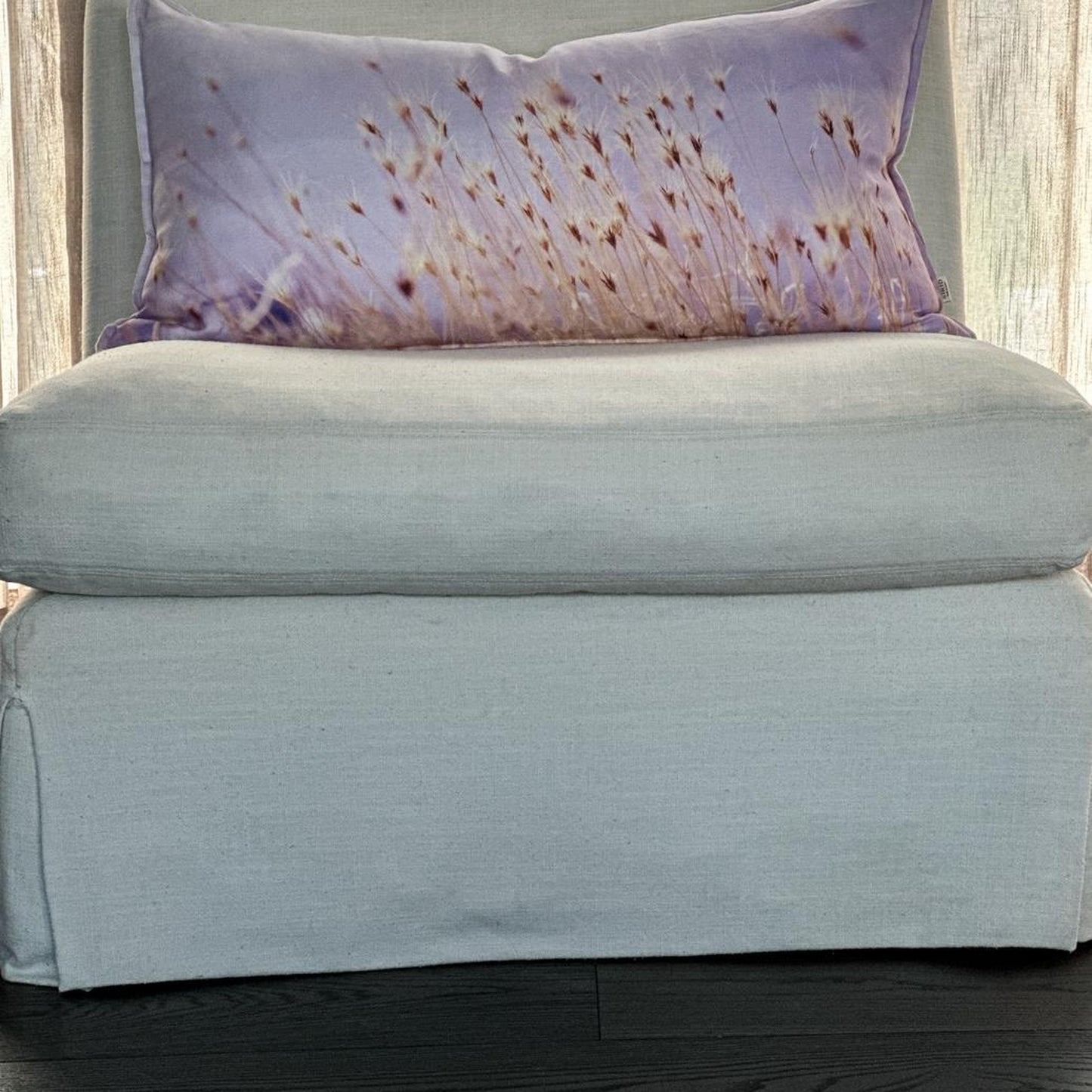Styled Prairie Grass linen pillow on a neutral chair, featuring golden Utah grass design